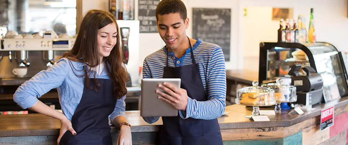 A teenager working in a coffee shop. Learn more about hiring young workers.