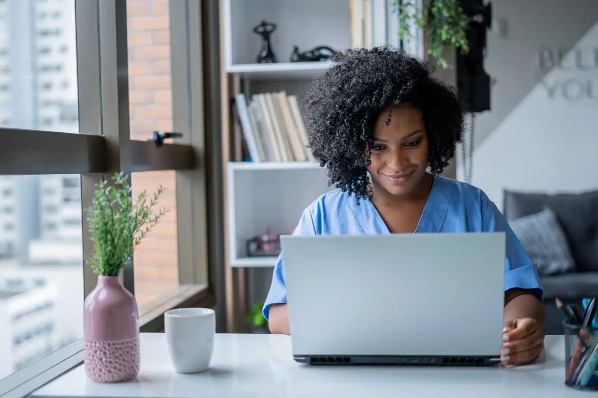 A nurse taking continuing education courses on her computer.