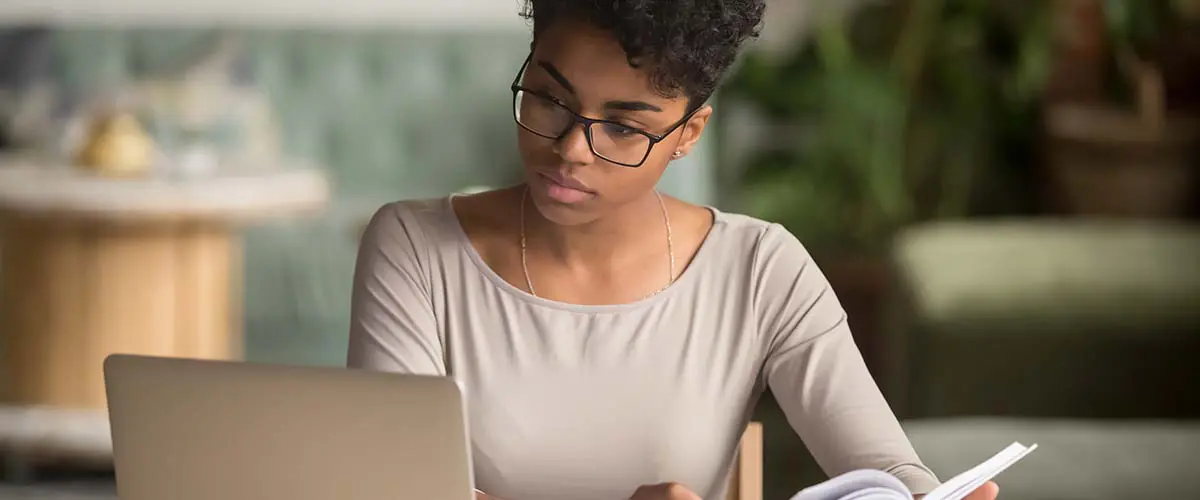 Image of young woman at home looking at a laptop.