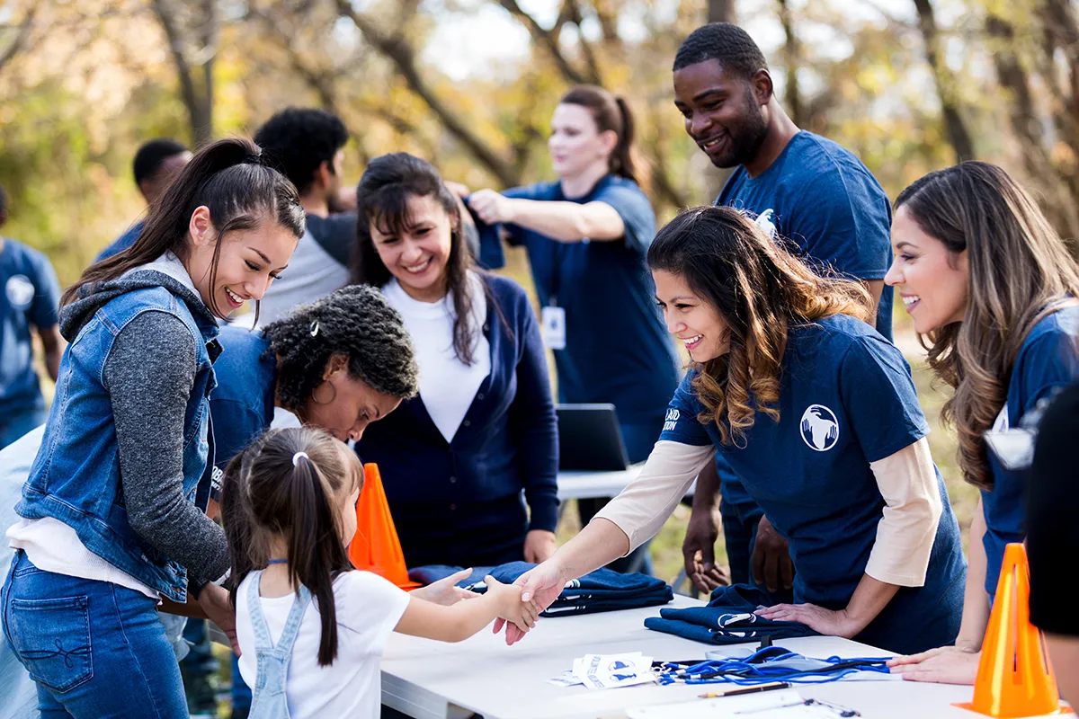 Volunteer working with children at an event